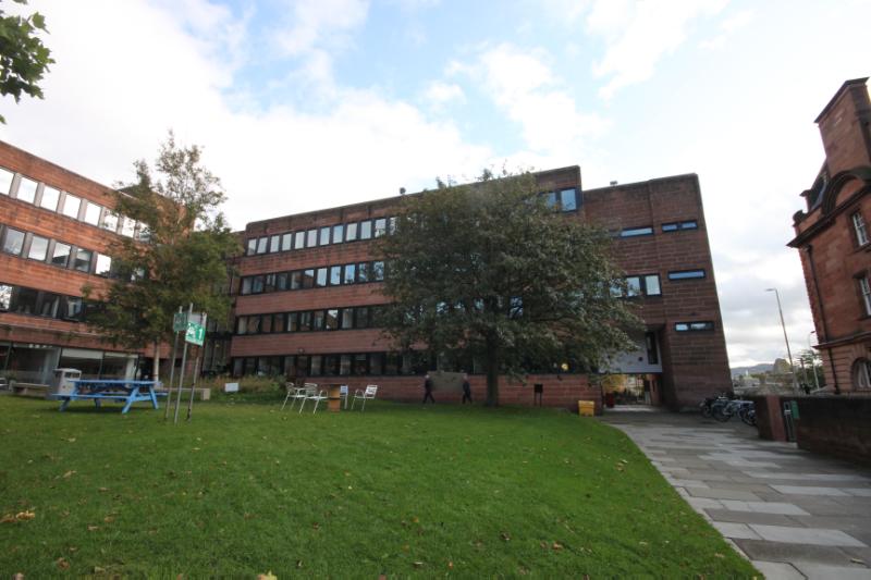 Hunter Building, courtyard elevations, looking south with trees and picnic benches in the courtyard.