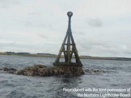 North Carr Beacon, standing on part-submerged reef off Fife Ness. Cloudy day.  