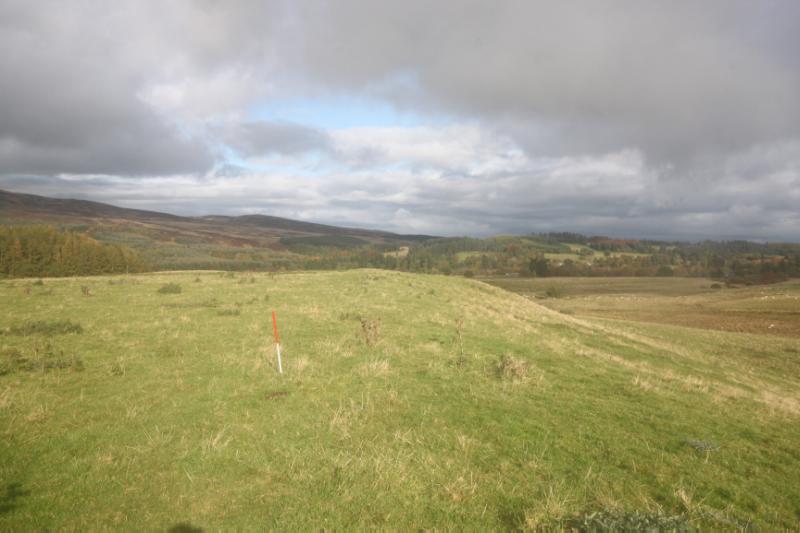 Fendoch Roman fort and annexe, 370m SSE of Fendoch Cottage, looking northeast along traces of southern rampart and ditch with fort interior to left and annex to right on a cloudy day. 