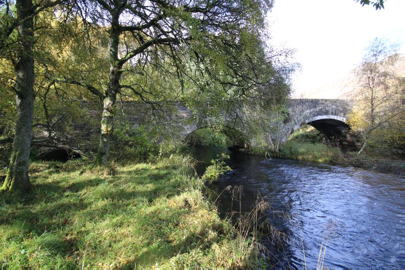 View of west elevation of Amulree bridge showing its tree arches. Looking northwest on a clear day. 