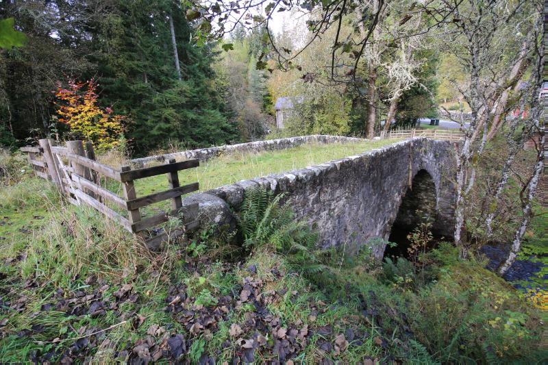 View of Old Trinafour Bridge from the southeast surround by trees.