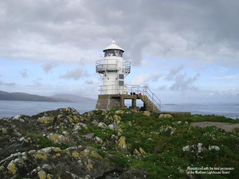 Ruadh Sgeir Lighthouse, Sound of Jura, during daytime, on clear day with blue sky. 