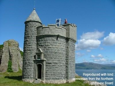 William Black Memorial Lighthouse, next to coast, looking towards tower and doorway. Sunny day.  