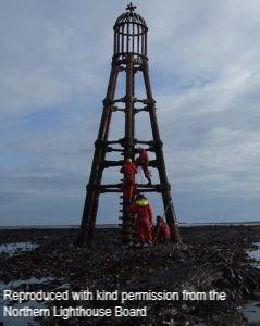The Riv Beacon, standing on part-submerged reef off the north coast of the island of Sanday. Low tide, with staff from the Northern Lighthouse Board undertaking maintenance work. 