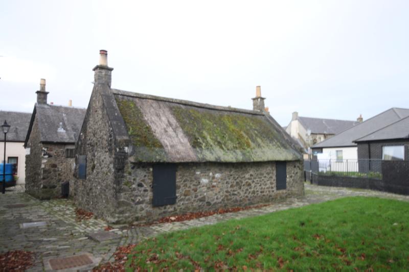 Rear (east) elevation of buildings at 10 Glasgow Vennel, looking northwest, during daytime, on clear day with cloudy sky. 