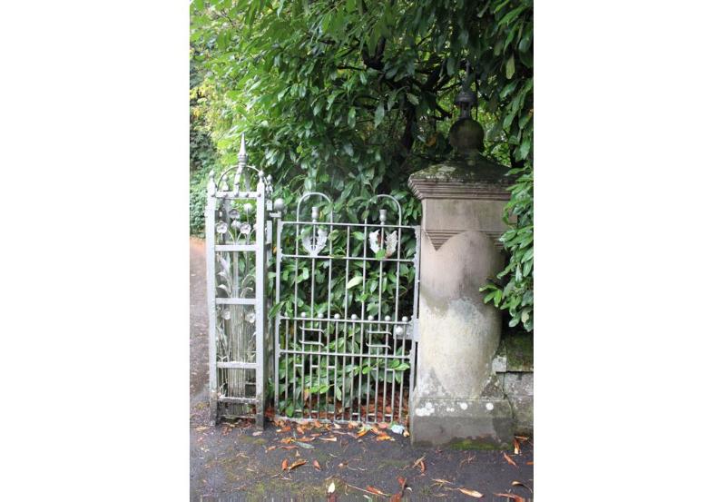 Detail of stone and iron gatepiers on a rainy day