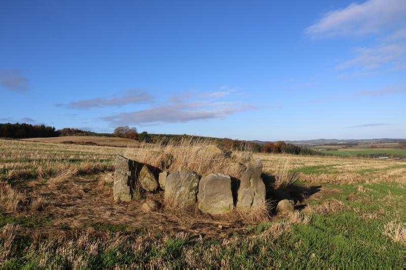 Four poster stone circle, 365m WSW of Raich Farm, looking northeast, during daytime, on clear day with blue sky.