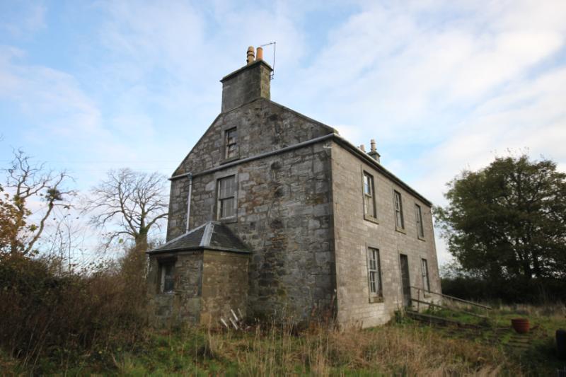 Cameron Farmhouse from southwest showing dairy outshot to west gable, during daytime with partially cloudy sky.