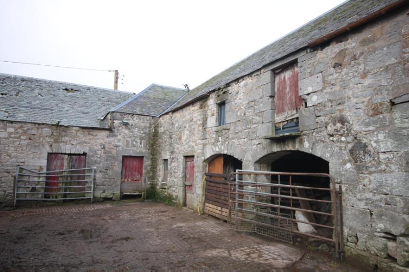 Cameron Farm Steading, north range from courtyard interior during daytime with white sky.