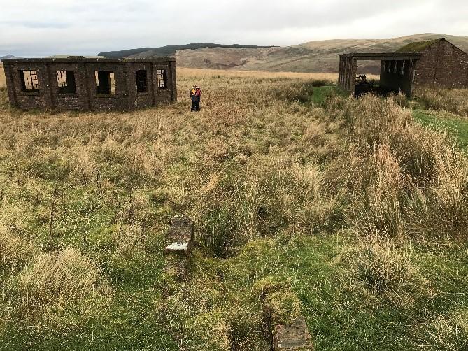 Blakebillend, tracked target range, 750m WNW and 570m and 740m NW of Penchrise Peel, looking east towards the power and winding house, maintenance shed and range warden’s hut, on a cloudy day.