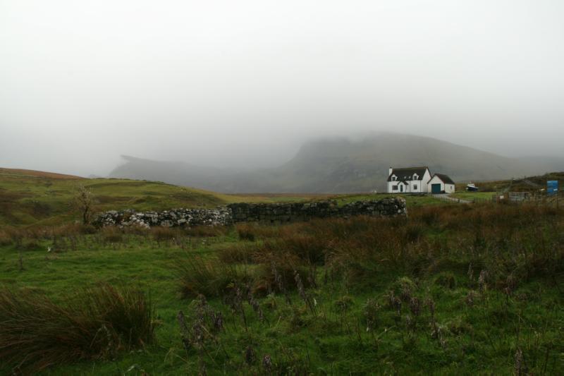 Walled remains of 1-6 Conista Byres in foreground, looking south, during daytime, on a foggy day. 