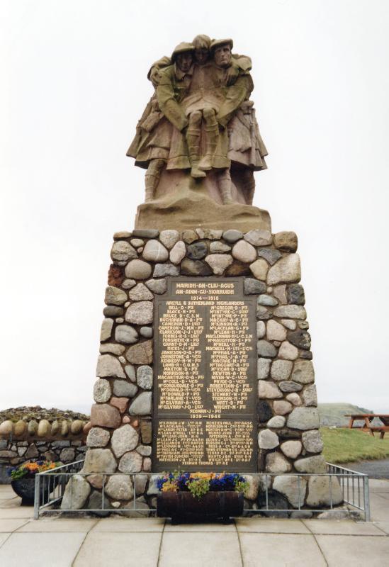 War memorial and cup-marked stone, Corran Esplanade, Oban, principal elevation, looking northwest, during daytime, on a cloudy day. 