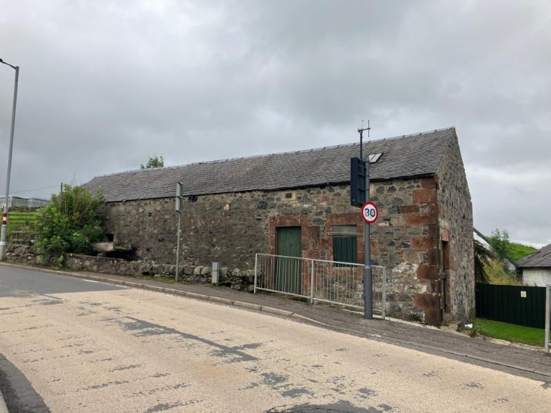 Mossmark of Oldmill, former mill building main (east) elevation, looking west, during daytime with cloudy sky