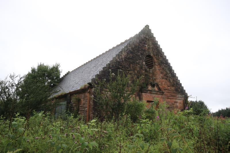 North building at Glassford Water Works, principal elevation, looking northwest, during daytime, with cloudy sky and vegetation in the foreground. 