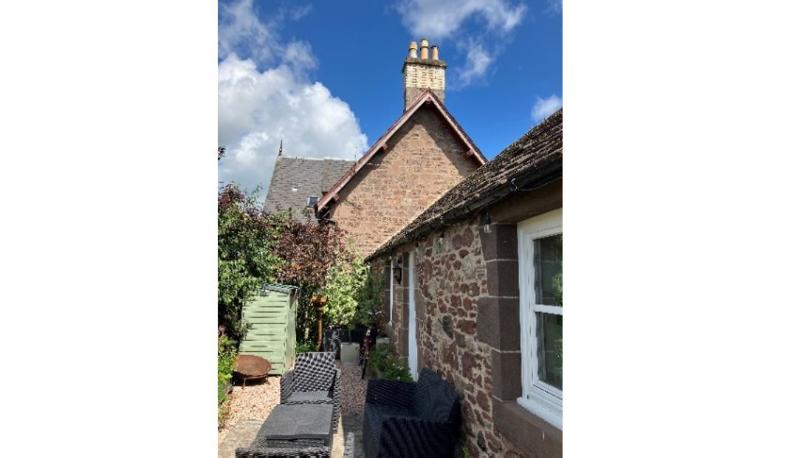 : Marchmont Cottage, The Square, Meigle principal elevation, looking north, on clear day with blue sky. 