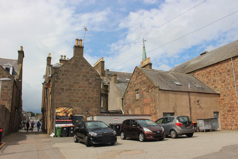 30 and 32 Allardice Street and 3-11 Market Lane, rear elevation, looking west during daytime, on clear day with blue sky. 
