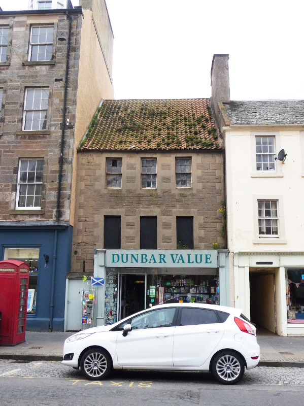 86 and 88 Hight Street, Dunbar, principal elevation, looking west, during daytime, on a cloudy day with a white car in the foreground. 