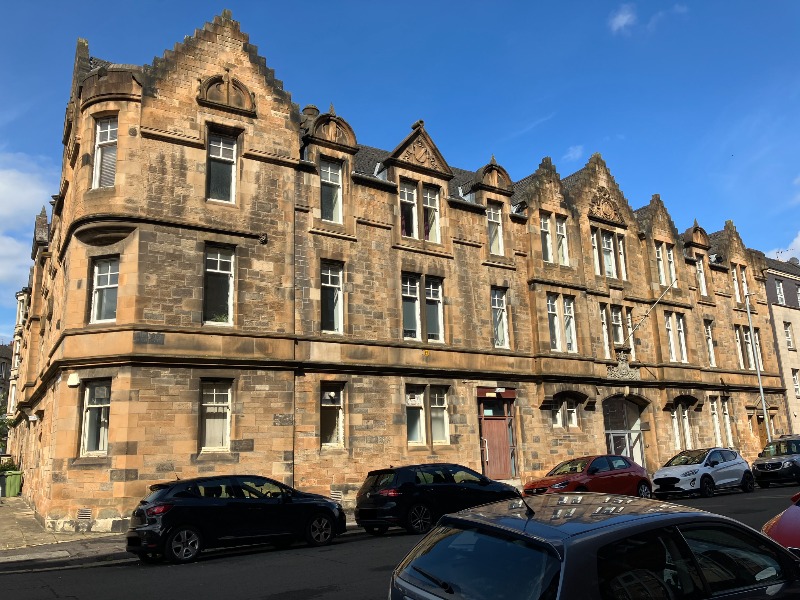 Former police station buildings, principal elevation, looking northwest, during daytime with blue sky.