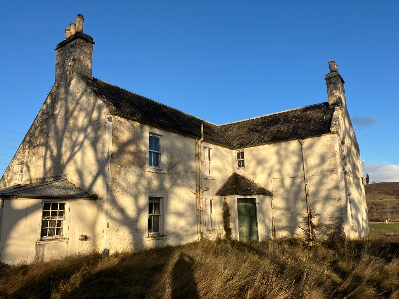 Torboll Farm, Dornoch, including farmhouse, walled garden, icehouse, steading, stable and mill lade, excluding four-bay cottage to west of site, sawmill and all other outbuildings, entrance elevation, on a sunny day with blue skies. 