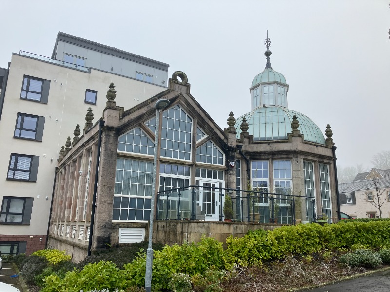 Stone conservatory of former Broadfield Hospital (previously Broadstone House) principal elevation, looking east, during daytime, on overcast day. 