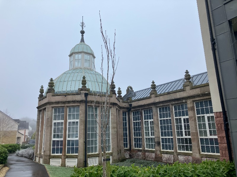 Stone conservatory of former Broadfield Hospital (previously Broadstone House side elevation, looking west, during daytime, on overcast day. 
