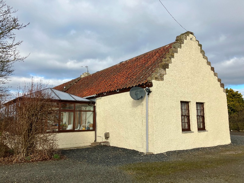 The Barn Easter Grange, southeast gable, looking north, during daytime on a cloudy day, showing conservatory to rear. 