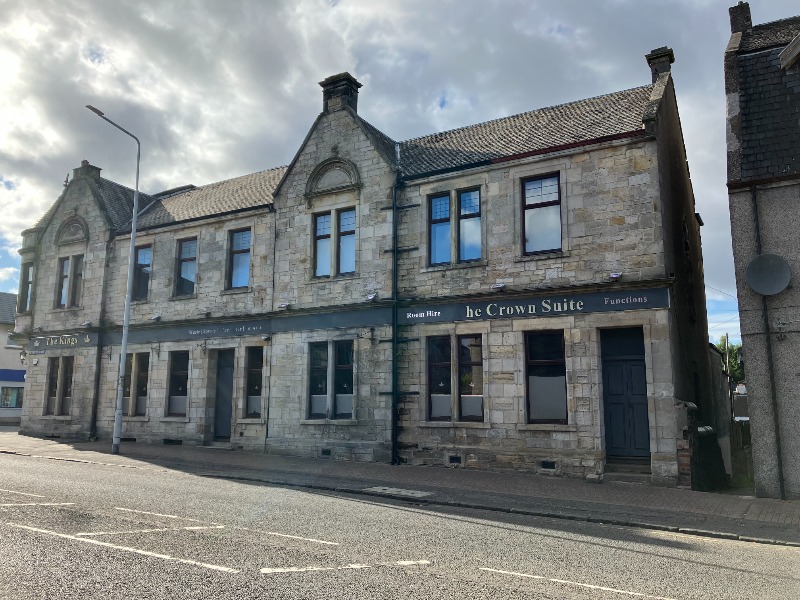 2-8 Main Street, Kelty, south elevation, looking northwest, during daytime, on clear day with a cloudy sky.